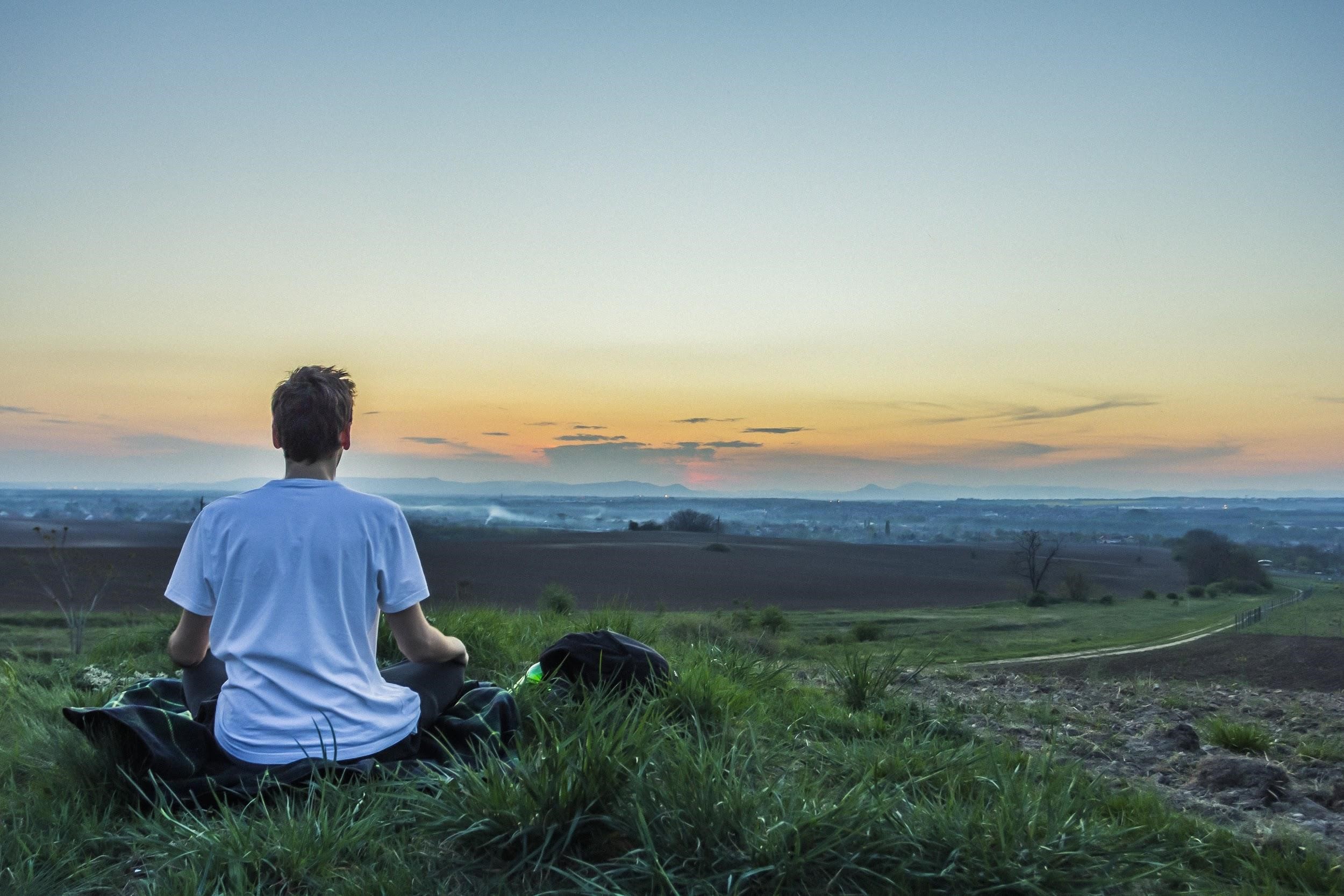 Person Meditating At Sunrise