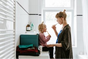 mother and child brushing their teeth