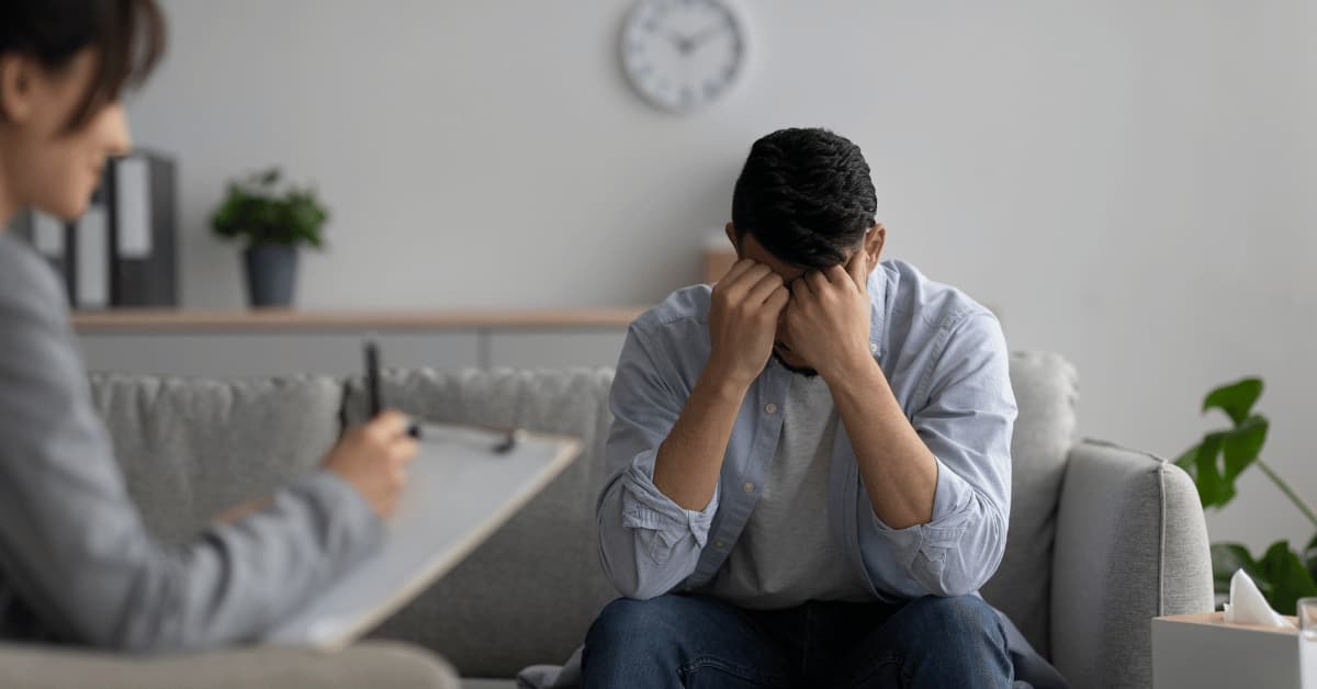 Man sad with head in hands